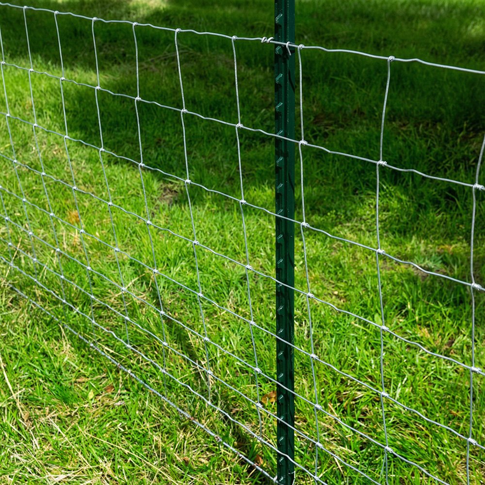 Green painted studded T post installed with farm fence wire for ranch fencing